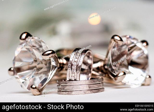 Close-up of two Wedding rings on a diamond shaped crystal or glass on a weddings day