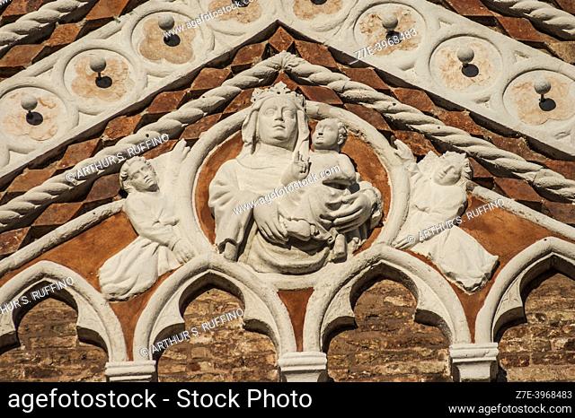 Sculptural detail of Madonna and Child. Façade of the Church of the Madonna of the Garden (Chiesa della Madonna dell'Orto). Telephoto
