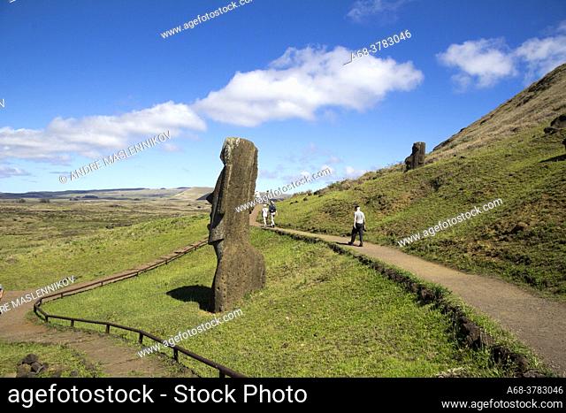 Stone sculptures, Moai, at the stone quarry on the slope to the crater Rano Raraku which is an extinct volcanic crater on Easter Island