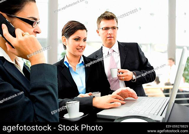 Businesspeople having discussion over coffee table