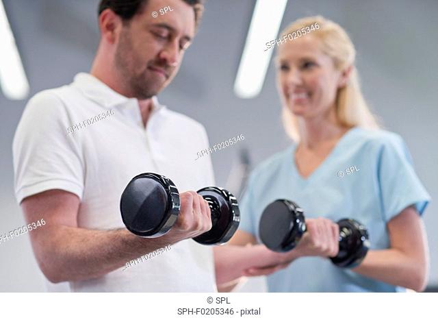 Nurse showing man how to use hand weights