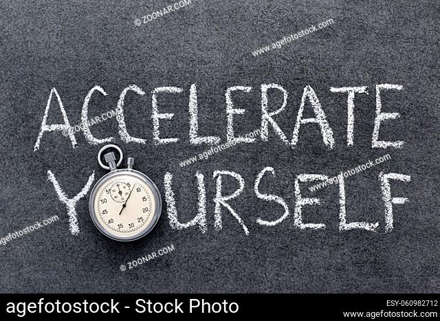 accelerate yourself phrase handwritten on chalkboard with vintage precise stopwatch used instead of O