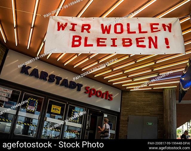 17 August 2020, Berlin: A banner with the inscription ""We want to stay!"" hangs on the Karstadt Sport branch of Galeria Kaufhof Karstadt GmbH near...