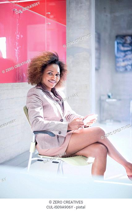 Young woman in office waiting room