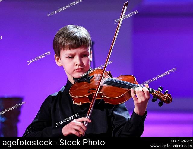 RUSSIA, MOSCOW - DECEMBER 12, 2023: The third place winner in the string category, violinist Alexander Kolesnikov, performs during an award ceremony for the...