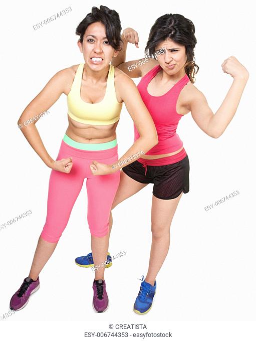 Cute Latina sisters flexing muscles over white background