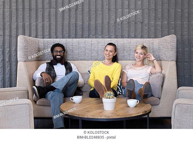 Portrait of smiling friends in lounge
