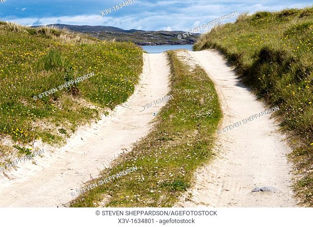 Europe, UK, Scotland, Outer Hebrides, Vatersay - a small sandy track leading to the sea