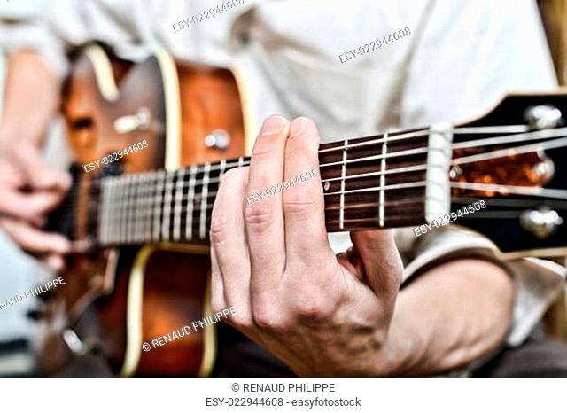 close-up on the fingers of the guitarist