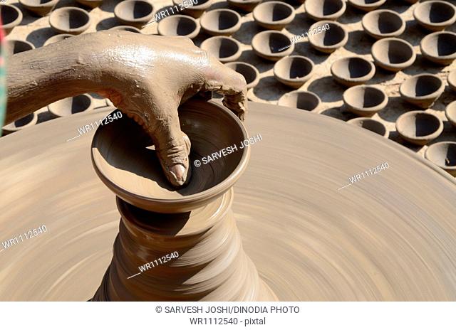 potter making clay pot on pottery wheel at Jodhpur Rajasthan India