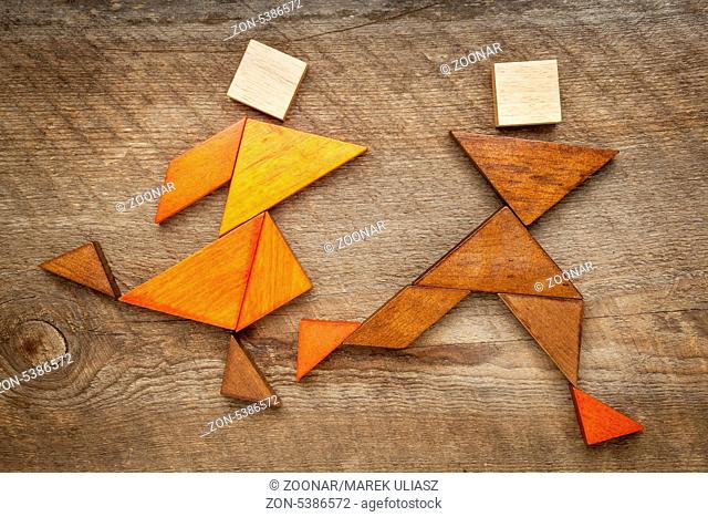 a couple of runners or athletes - abstract figures built from tangram wooden pieces, a traditional Chinese puzzle game, artwork created by the photographer
