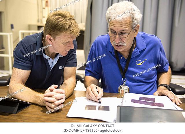 European Space Agency astronaut Timothy Peake (left), Expedition 4647 flight engineer, prepares for a training session in the Cupola trainer in the systems...