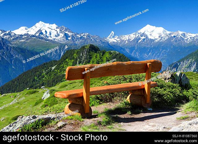 Swiss Alps: Wooden bench with the Mischabel group, the Matterhorn and the Weisshorn in the background. Valais, Switzerland