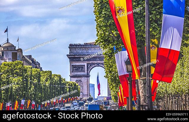 Avenue Champs Elysees Traffic Arc de Triomphe French Spanish Flags View Cityscape City Center Paris France. Spanish Prime Minister visiting Paris