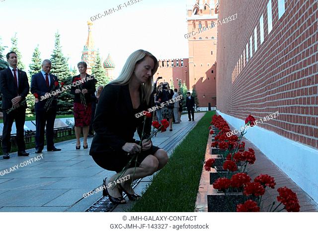 At the Kremlin Wall in Moscow's Red Square, Expedition 48-49 crew member Kate Rubins of NASA lays flowers where Russian space icons are interred during...