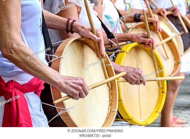 Womans percussionists playing drums during folk samba performance on Belo Horizonte, Minas Gerais