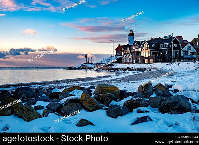 snow covered beach during wnter by Urk lighthouse in the Netherlands. cold winter weather in the Netherlands