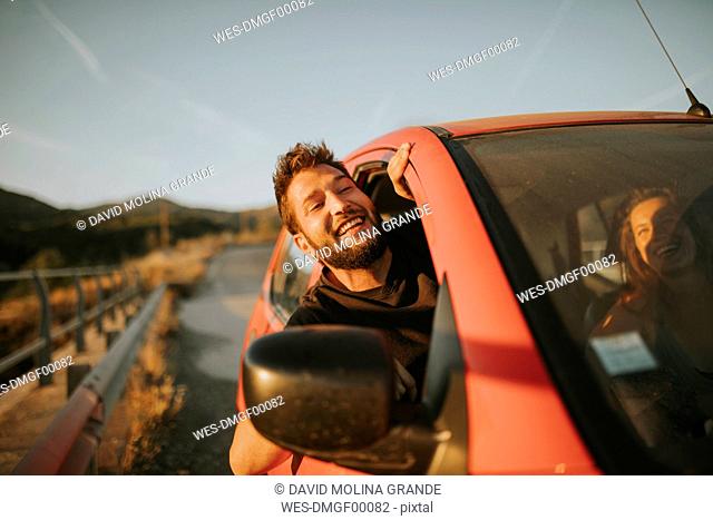 Man on a road trip looking out of car window