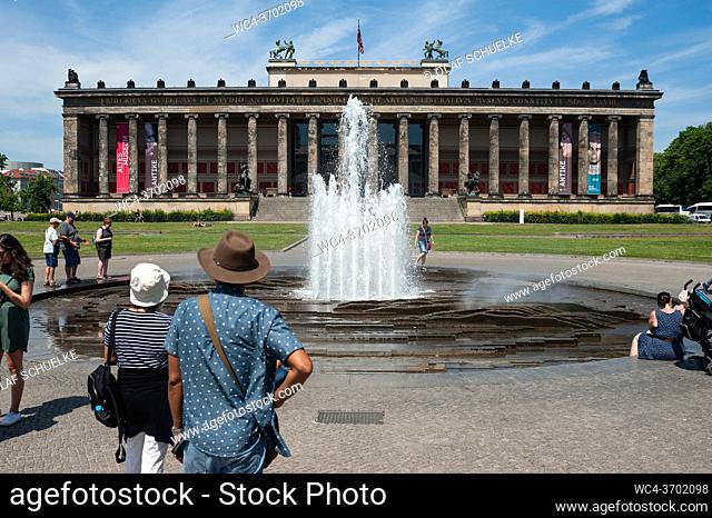 Berlin, Germany, Europe - Tourists stand by the water fountain at the Lustgarten with the Altes Museum (Old Museum) on Museum Island in Berlin's Mitte locality