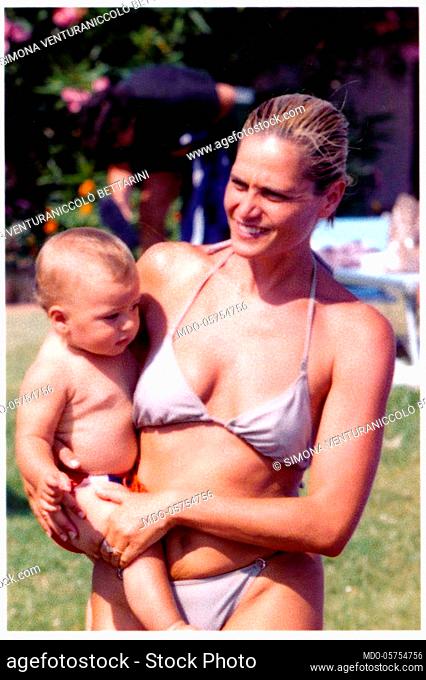 Italian television presenter and showgirl Simona Ventura with her son Niccolò in her arms. 1999