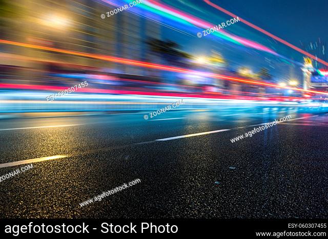 speeding lights of cars in city at night