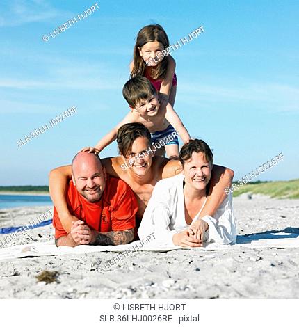 Family playing together on beach towel