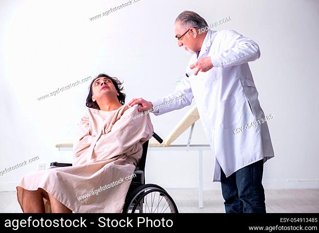 The old male doctor psychiatrist and patient in wheel-chair