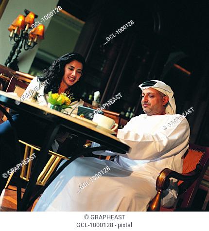 Meeting of Arab businesspeople in a cafe