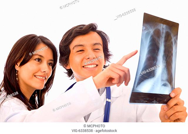 couple of doctor watching an xray over a white background - 20/10/2008