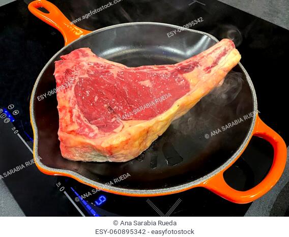 Cured beef steak cooked in high temperature cast iron skillet