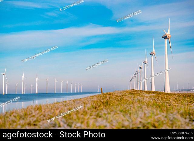 offshore windmill park with stormy clouds and a blue sky, windmill park in the ocean. Netherlands . Europe, windmill turbines in ocean with blue sky
