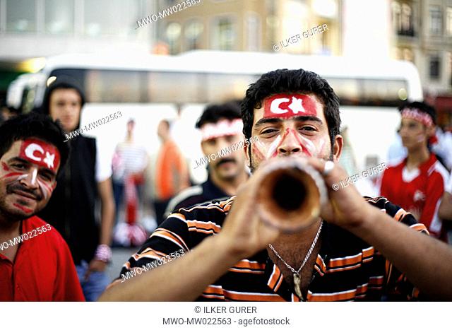 People play music and enjoy themselves before a football game between Turkey and Germany in Taksim square, the hub of modern Istanbul Istanbul, Turkey June 25
