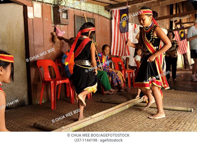 Bidayuh girls are performing bamboo dance at Annah Rais's long house during Gawai Festival(Harvesting Season), Sarawak, Malaysia