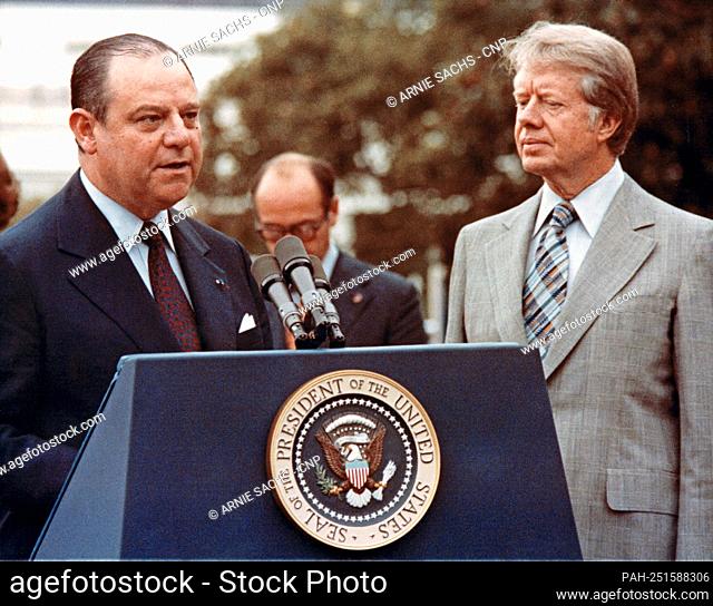 United States President Jimmy Carter, right, looks on as Prime Minister Raymond Barre of France, left, makes remarks during the full honor arrival ceremony on...