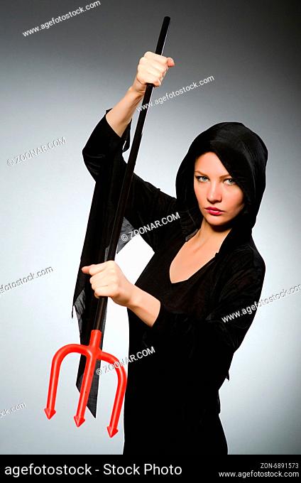 Halloween concept with woman holding pitchfork