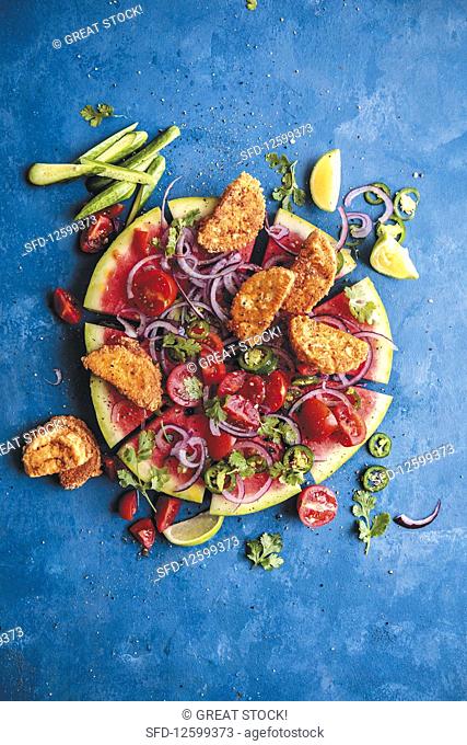 Watermelon pizza with fried feta cheese and vegetables