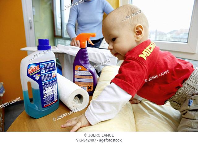 A little child grabs to cleanser in household. - LEIPZIG, GERMANY, 01/12/2006