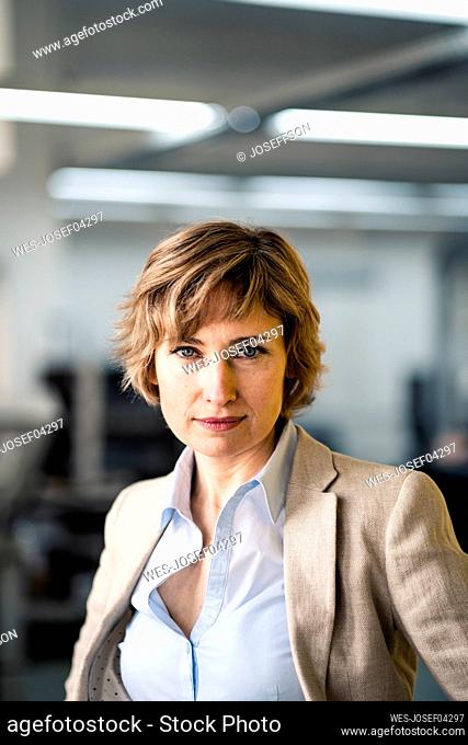 Confident businesswoman in factory