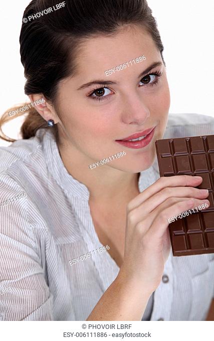 Young woman with a huge bar of chocolate