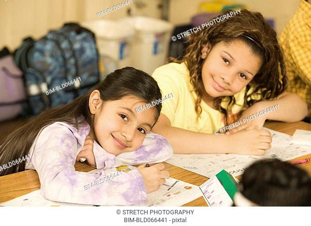 School girls writing at desks