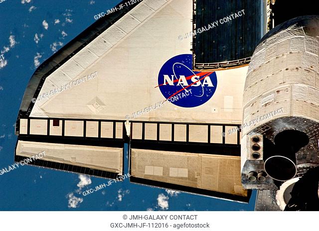 This partial view of the port wing of the space shuttle Discovery was provided by an Expedition 26 crew member during a survey of the approaching STS-133...