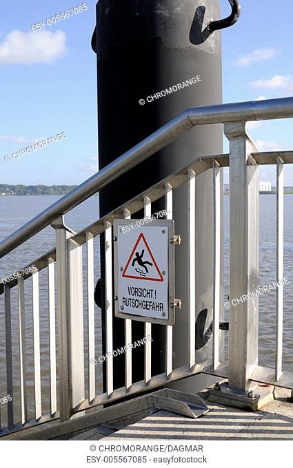 Sign caution slip hazard in the Port of Hamburg, Germany