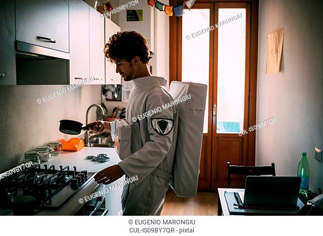 Astronaut cooking in kitchen