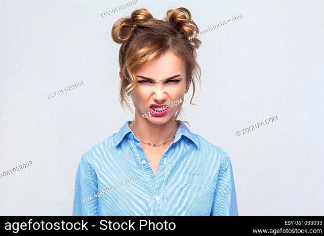 Roar! Anger woman shout at camera. Bad emotions and feelings. Isolated on gray background