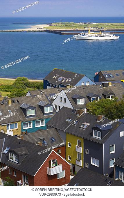 Helgoland Germany colorful houses in town seen from the plateau of the main island toward the island Düne / Dune with ship