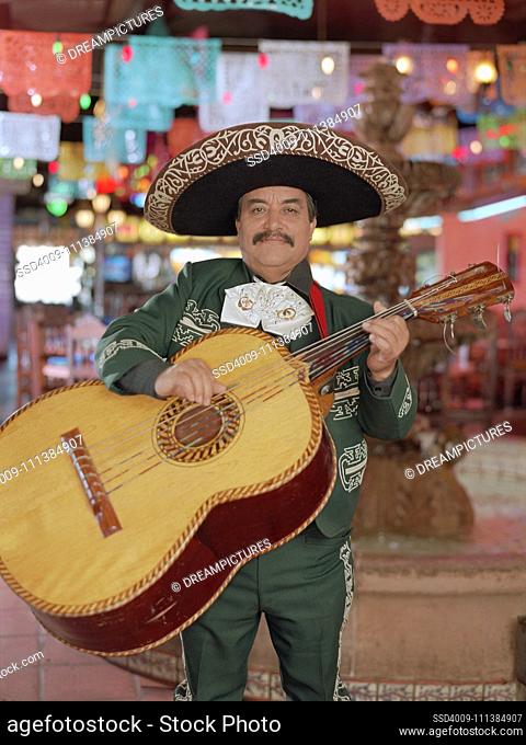 Hispanic mariachi musician playing guitar