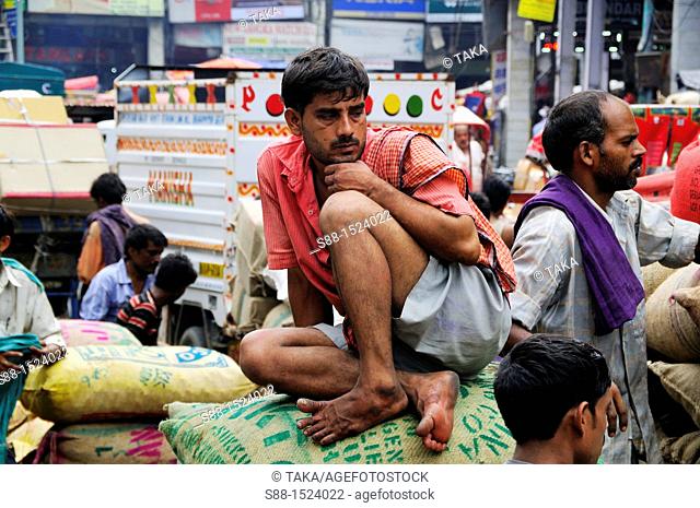 Man who load sack of grain having rest at Chandni Chowk, Old Delhi