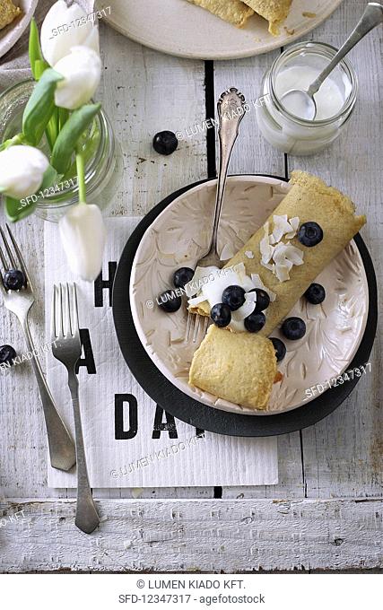 Gluten-free pancakes with coconut flakes and blueberries