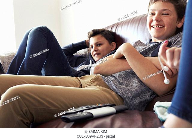 Two boys laughing on sofa