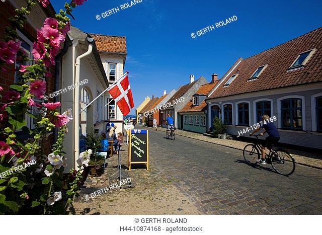 Aeroskobing, Denmark, island, isle, Aero, town, city, houses, homes, street, cobblestone, bicycle driver, flowers, mallows, Denmark flag